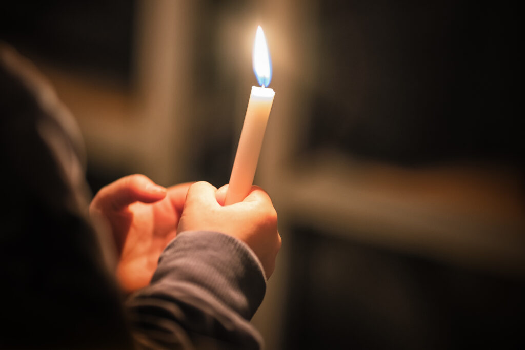 child holding candel